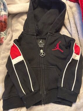 Air Jordan Black Zip Hoodie with Red and White Accents.